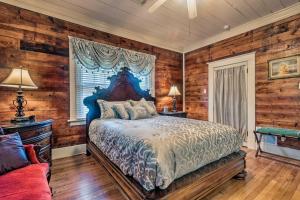 a bedroom with wooden walls and a bed and a window at Spacious and Updated 1920s HSNP Craftsmen Home in Hot Springs