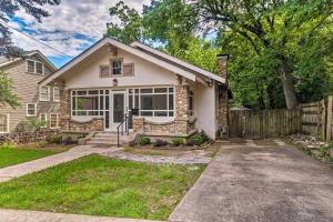 a white house with a fence in a yard at Spacious and Updated 1920s HSNP Craftsmen Home in Hot Springs