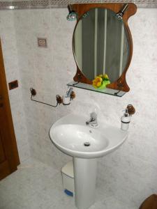 a bathroom with a white sink and a mirror at Affittacamere Casa Sofia in Anghiari