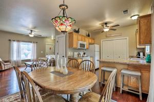 a kitchen and dining room with a table and chairs at Lovely Kanab Condo in Dwtn, 30 mi to Zion NP! in Kanab