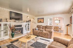 a living room with a fireplace and a tv at Panguitch Home with Patio about 24 Mi to Bryce Canyon in Panguitch