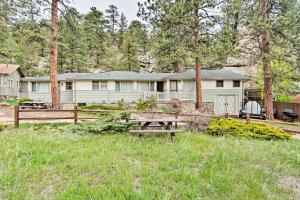 a picnic table in the grass in front of a house at Estes Park Home about 8 Mi to Rocky Mtn Natl Park! in Drake
