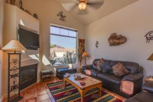a living room with a leather couch and a table at Rim Village Two-Bedroom in Moab