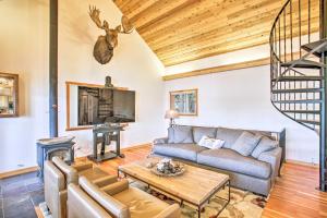 a living room with a couch and a table at South Lake Coeur dAlene Home with Dock and Kayaks! in Worley