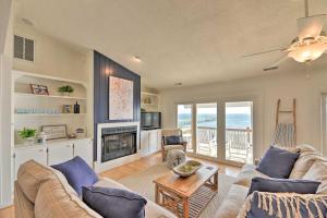 a living room with a couch and a fireplace at Waterfront Harkers Island Home Sunset View and Dock in Harkers Island