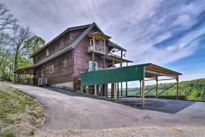 a large wooden house on the side of a road at Spacious Cabin on Dale Hollow Lake with Hot Tub! in Albany