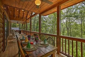 a wooden porch with a table and chairs on it at A Sunset Dream - Upscale Blue Ridge Cabin! in Cherry Log