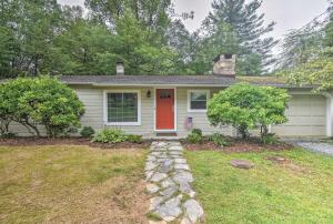 a house with a red door in a yard at Blowing Rock Home 1 Block to Downtown! in Blowing Rock