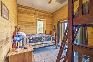 a bedroom with a bed in a log cabin at Spacious Cabin on Dale Hollow Lake with Hot Tub! in Albany
