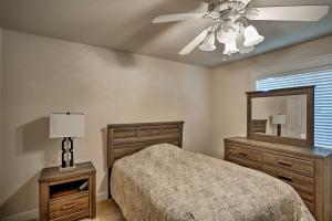 a bedroom with a bed and a mirror and a ceiling fan at Spacious Downtown Chico Home about Half Mile to CSU! in Chico