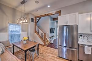 a kitchen and dining room with a stainless steel refrigerator at Updated Indianapolis Home, Walk to Lucas Oil! in Indianapolis