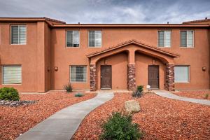 a brick building with two doors in a yard at Kanab Condo with Pool and Patio, 30 Mi to Zion NP in Kanab