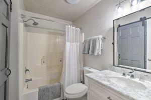 a bathroom with a toilet and a sink and a shower at Modern Flagstaff Home with BBQ Walk Downtown! in Flagstaff +16 photos
