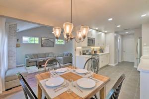 a dining room and living room with a table and chairs at Modern Flagstaff Home with BBQ, Walk Downtown! in Flagstaff