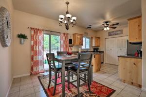 a kitchen and dining room with a table and chairs at Kanab Condo with Pool and Patio, 30 Mi to Zion NP in Kanab