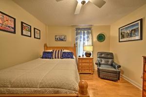 ein Schlafzimmer mit einem Bett und einem Stuhl in der Unterkunft Nags Head Apt with Patio - half Mile Walk to Beach! in Nags Head