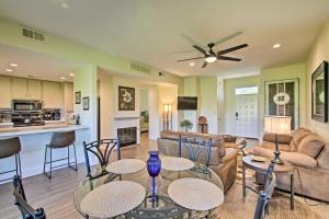 a living room with a couch and a table and chairs at Cathedral City Resort Condo on a Golf Course! in Cathedral City