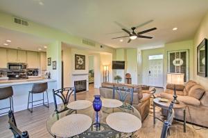 a living room with a couch and a table and chairs at Cathedral City Condo on Golf Course with Patio! in Cathedral City