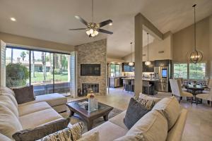 a living room with two couches and a fireplace at Luxury Remodeled Palm Desert Resort Condo! in Palm Desert