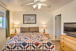 a bedroom with a bed and a flat screen tv at S Cottonwood Home with Yard, 3 Mi to Main St in Cottonwood