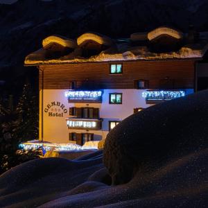 een gebouw met lichten aan de zijkant 's nachts bij Hotel Gembro in Chiesa in Valmalenco