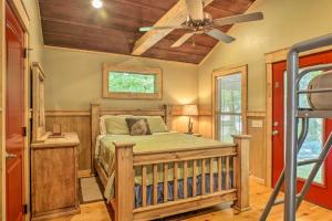 a bedroom with a bed and a ceiling fan at Guntersville Lake Cabin with 3 Fishing Ponds! in Guntersville