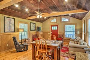 a living room with a table and chairs at Guntersville Lake Cabin with 3 Fishing Ponds! in Guntersville