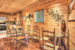 a dining room with a glass table and chairs at Rustic Gatlinburg Chalet with Hot Tub 2 Mi to Town in Gatlinburg