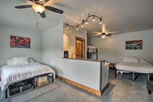 a bedroom with two beds and a table and a mirror at Modern Lava Hot Springs Studio, Walk to Pools in Lava Hot Springs