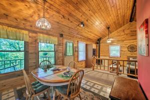 a dining room with a table and chairs in a cabin at Eureka Springs Studio with Deck, Views and BBQ! in Eureka Springs