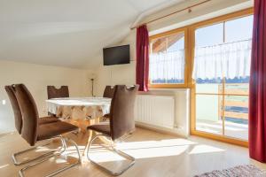 a dining room with a table and chairs and a window at Appartment Stiegler in Haus im Ennstal