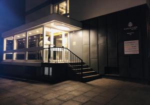 a building with a staircase in front of it at night at Elbgalerie Hotel in Hamburg