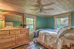- une chambre avec un lit et une commode avec un miroir dans l'établissement Cozy Candler Cottage - 11 Mi to DT Asheville!, à Candler
