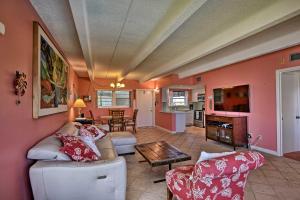 a living room with a couch and a table at Oceanfront Vero Beach Condo with Balcony Views! in Vero Beach