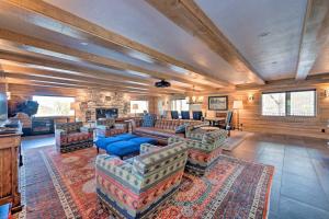 a large living room with couches and a fireplace at Renovated Historic Cabin about 25 Miles to Park City! in Samak