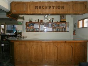 a bar in a restaurant with a sign that reads reception at Hotel Red Planet in Kathmandu