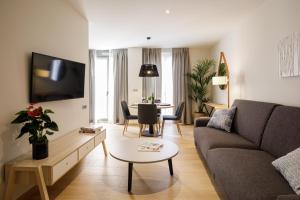 a living room with a couch and a table at Suites Castellón in Castellón de la Plana