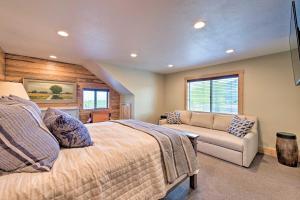 a bedroom with a bed and a couch at Renovated Historic Cabin about 25 Miles to Park City! in Samak