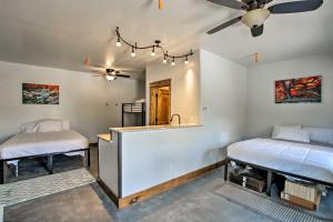 a room with two beds and a sink and a ceiling fan at Lava Hot Springs Studio 4-Min Walk to Pools! in Lava Hot Springs