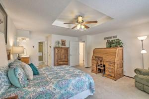 a bedroom with a bed and a desk and a ceiling fan at Lake of the Ozarks Home with Game Room, BBQ and Dock! in Osage Beach