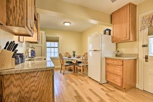 a kitchen with a white refrigerator and a table at Lexington Getaway with Backyard Deck Less Than 2 Mi to UK! in Lexington