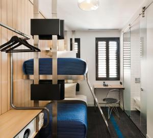 a bedroom with a bunk bed with a desk at Pod 39 in New York