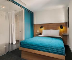 a bedroom with a bed with a blue blanket at Pod 39 in New York
