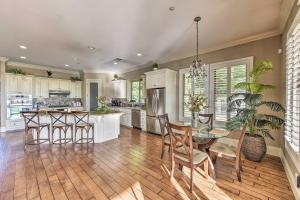 a kitchen with a table and chairs and a dining room at Elk Grove Getaway with Saltwater Pool Near Wineries! in Elk Grove