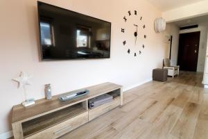 a living room with a flat screen tv on a wall at Bohinj - Old Village House in Bohinj