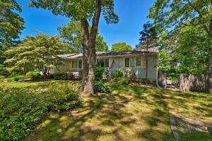 een huis met een boom in de tuin bij Cape Cod Area Home with Fire Pit Less Than 4 Mi to Beach! in East Falmouth
