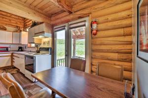 a kitchen with a table and chairs in a cabin at Cabin with Fire Pit, Views and BBQ 18 Mi to Moab! in Moab