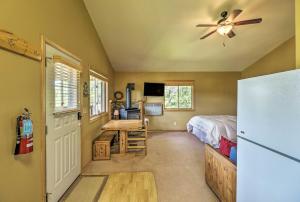 - une chambre avec un lit, un réfrigérateur et un bureau dans l'établissement Trego Resort -Style Cabin with Lake,Trails and 40 Acres, à Trego