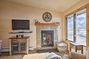 sala de estar con chimenea y TV de pantalla plana en Copper Mountain Resort Condo on Golf Course!, en Copper Mountain