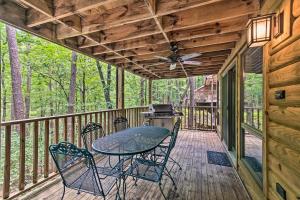 a patio with a table and chairs on a deck at Mount Ida Condo - Walk to Lake Ouachita! in Mount Ida